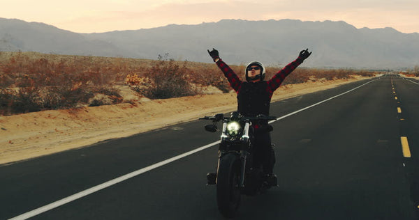 Motorcycle rider with a happy gesture