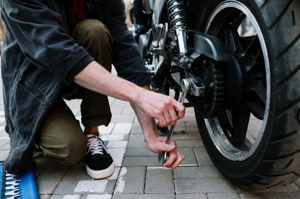 Man repairing his motorcycle